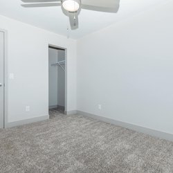 Carpeted second  bedoom with view of closet and door at North 49 Apartments, located in Colorado Springs, CO