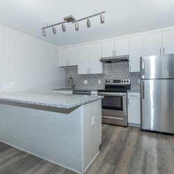 Stainless steel all electric kitchen with dining at the counter at North 49 Apartments, located in Colorado Springs, CO