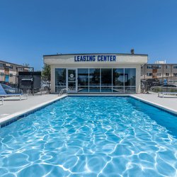 Swimming pool with lounge chairs at North 49 Apartments, located in Colorado Springs, CO 3